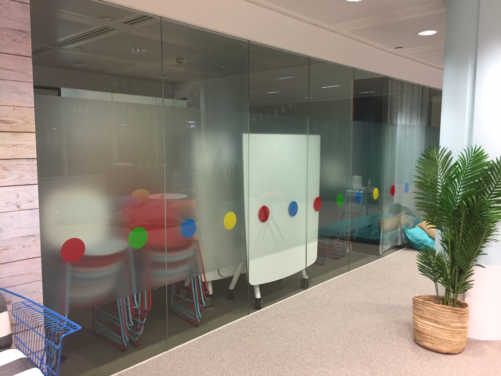 A photo of frosted window vinyl with coloured circle graphics