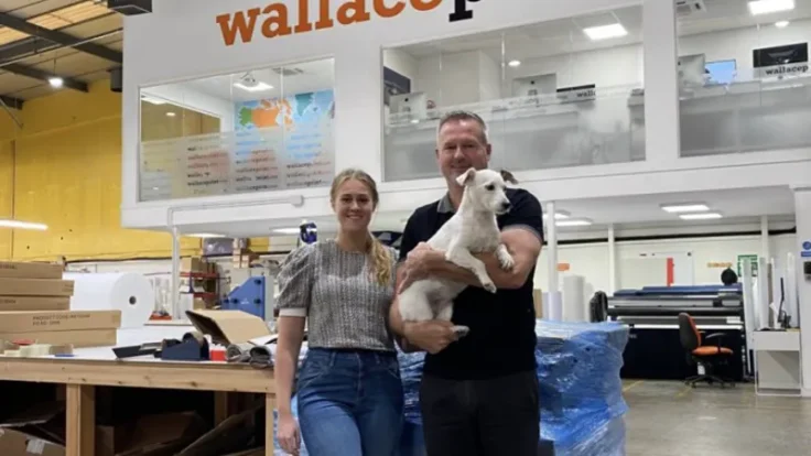 Mia and Gary Wallace with Mitzy the company mascot